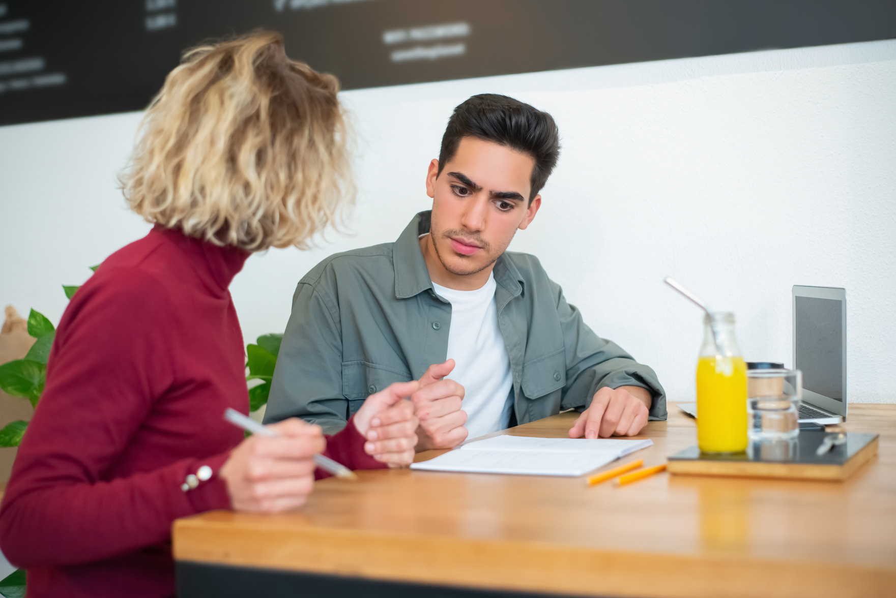 A Man and a Woman Having a Discussion in a Cafe